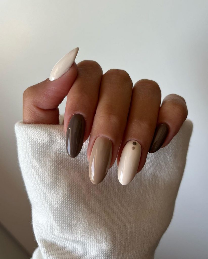 Mão encurvada com unhas em degradê marrom