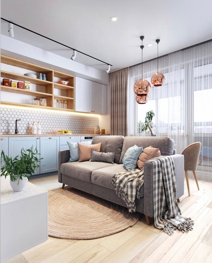 Sala e cozinha em tons pastel com pendentes rosé