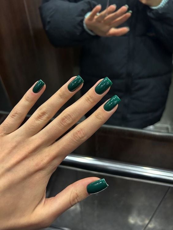Mão branca com unha quadrada verde esmeralda