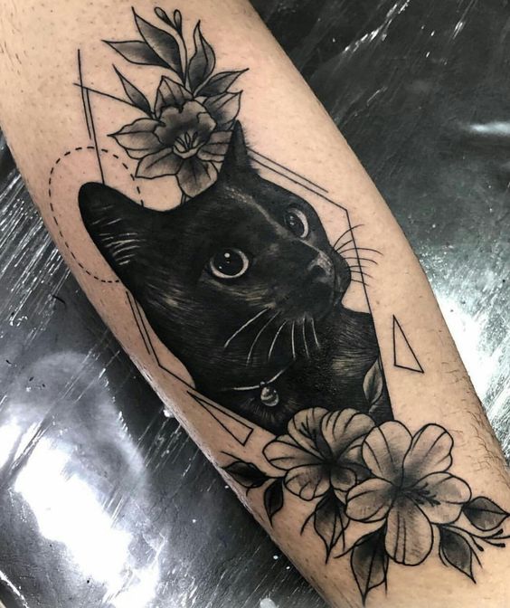 Tatuagem de gato em braço de pele clara.