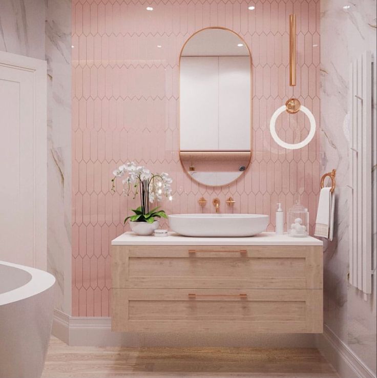 Banheiro rosa e branco com destaque para o rose gold
