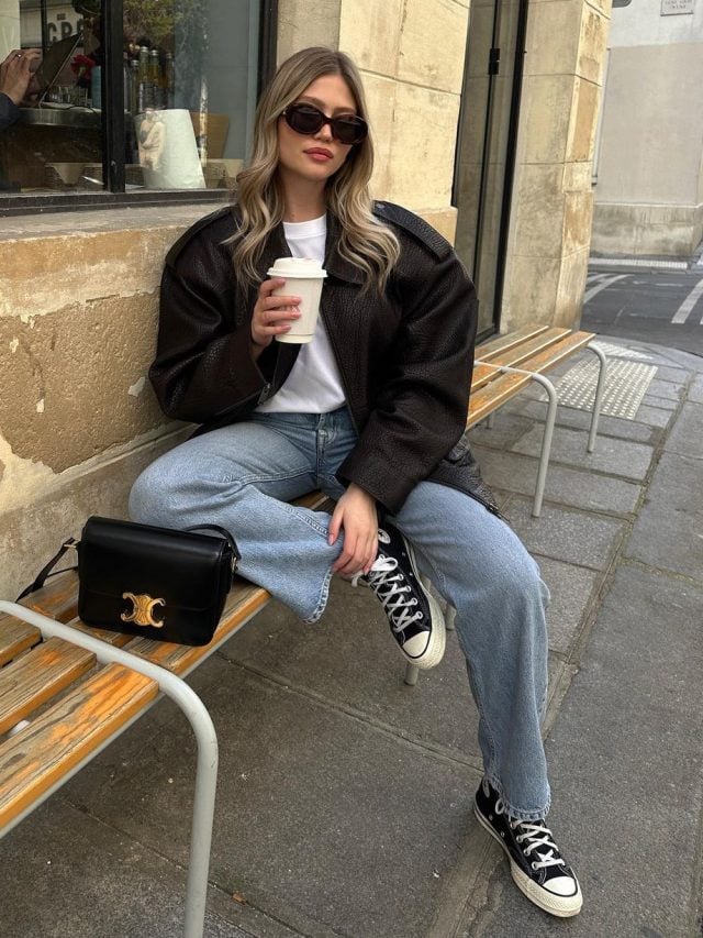Marine Diet com jaqueta de couro, camiseta branca, calça jeans de lavagem clara e All Star preto