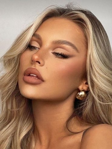 Mulher branca com cabelo loiro e maquiagem com delineado esfumado