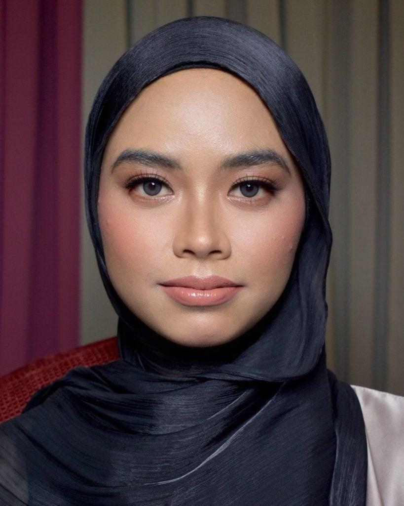 Mulher branca muçulmana com hijab preto e maquiagem clean