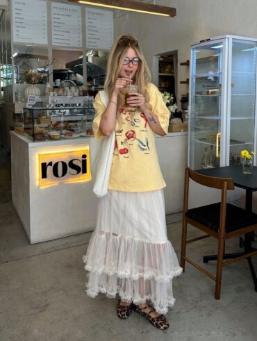 Julia com camiseta estampada, maxi bag branca, saia midi de tule e sapatilha Mary Jane animal print