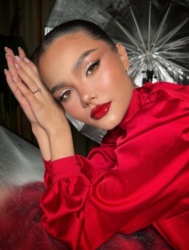 Mulher de pele preta, com roupa e lábio vermelho
