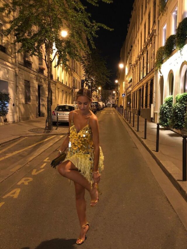 Mulher de pele clara, com vestido curto dourado