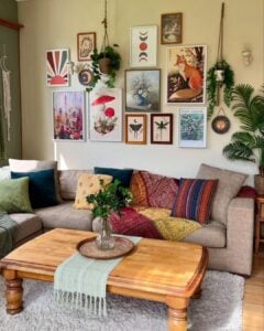Sala de estar com quadros coloridos de diferentes tamanhos e almofadas coloridas no sofá