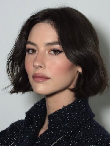 Gracie Abrams, com roupa preta, cabelo curto preto e watercolour makeup