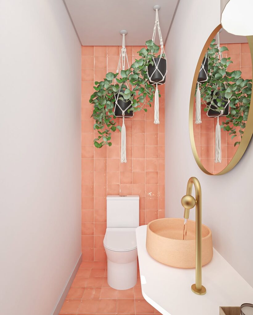 Lavabo pequeno com azulejo rosa e plantas