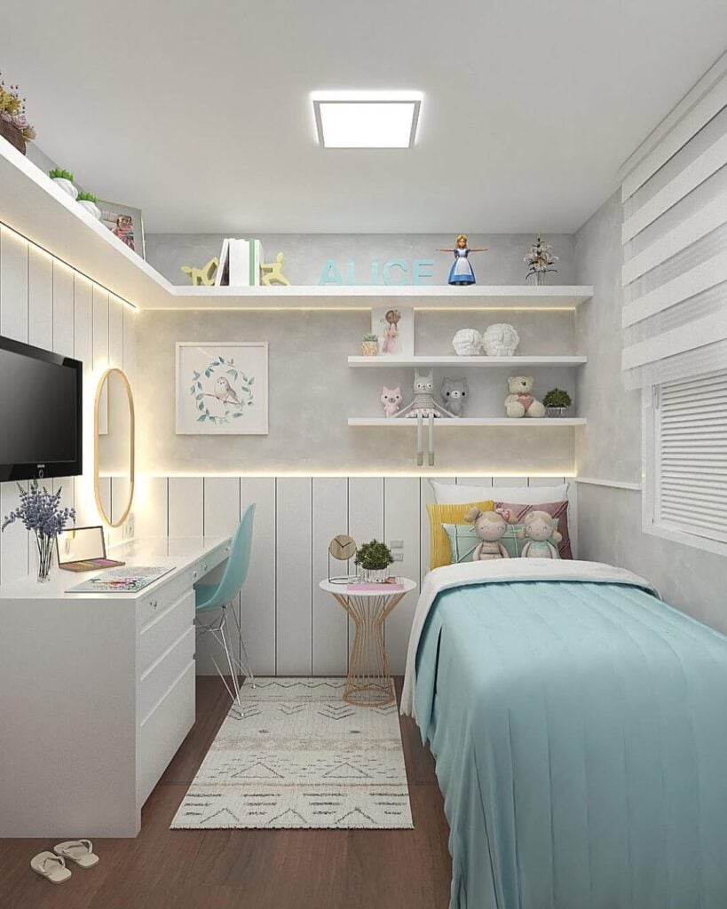 Quarto infantil branco com detalhes em azul, prateleiras no alto e escrivaninha e penteadeira integradas
