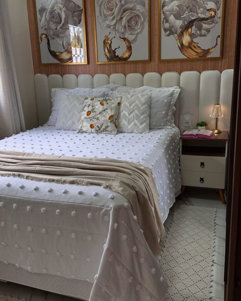 Cama com cabeceira modular estofada, colcha branca e almofadas