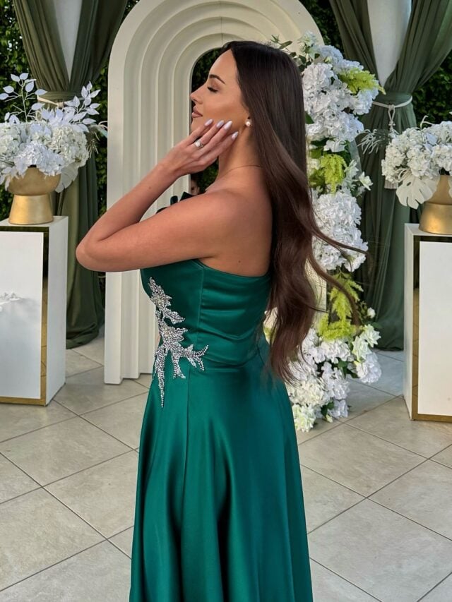Mulher de pele clara, com vestido verde e cabelo castanho