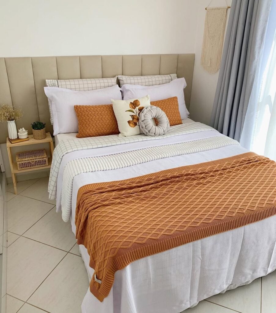 Cama posta em branco e terracota, cabeceira estofada modula, almofadas e manta com texturas
