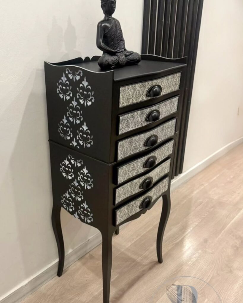 Móvel preto com gavetas estreitas e decoração com estêncil