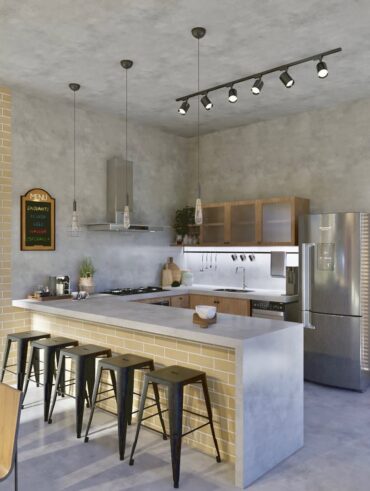 Cozinha com revestimento e piso em cimento queimado, com bancada americana, spots de luz e pendentes