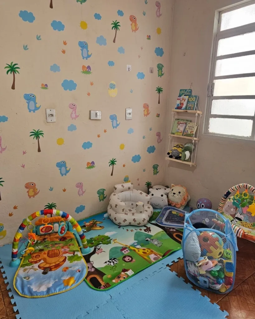 Ambiente com almofadas em formato de animais, tapetes coloridos e papel de parede
