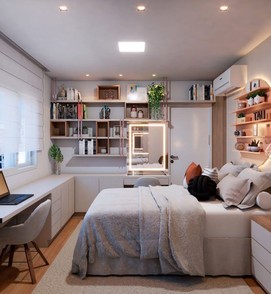Quarto feminino com almofadas e manta na cama, estante com livros e escrivaninha