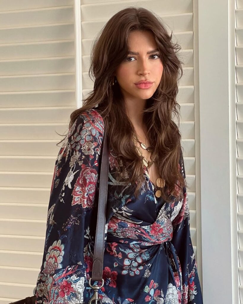 Lele Burnier com blusa boho e cabelo escuro longo com corte butterfly
