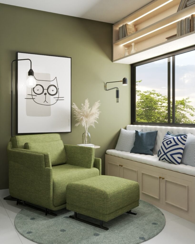 Sala de estar com sofá e parede verde com quadro branco