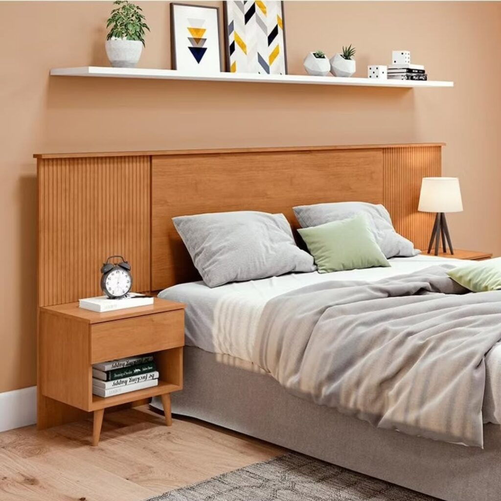 Cama de casal com cabeceira de madeira e prateleira branca com objetos decorativos