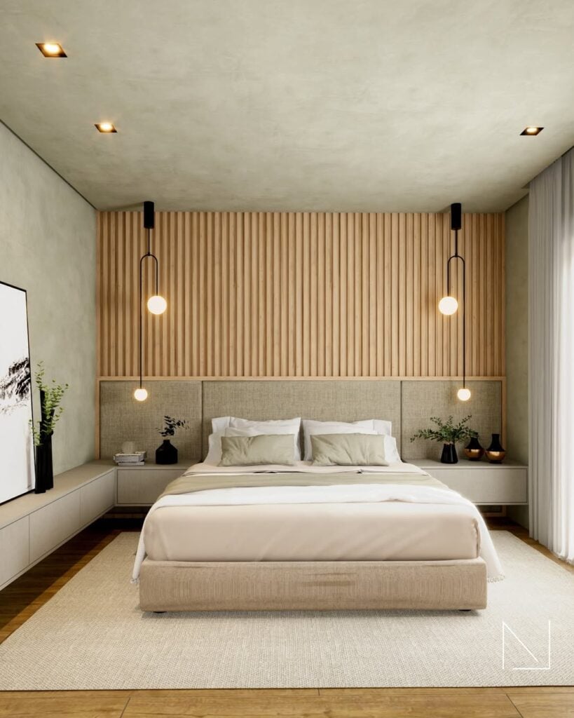 Quarto de casal com cabeceira estofada, parede ripada acima da cabeceira e pendentes no estilo industrial