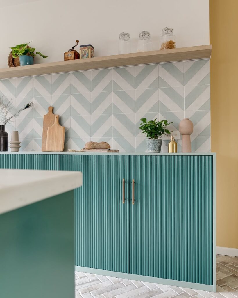 Armário de cozinha com portas azuis, azulejos em branco e preto