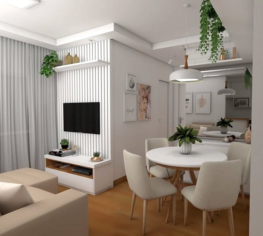 Sala de estar e jantar branca com mesa redonda e vaso de plantas no centro