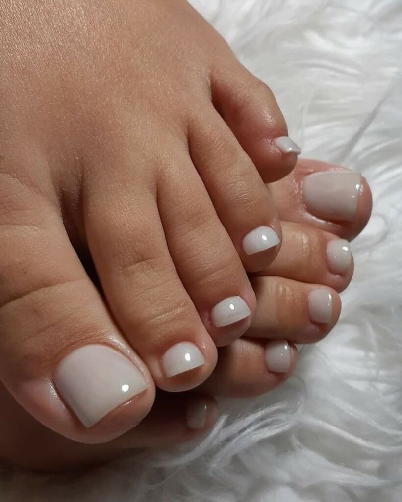Pés de pele clara, com unhas milky white