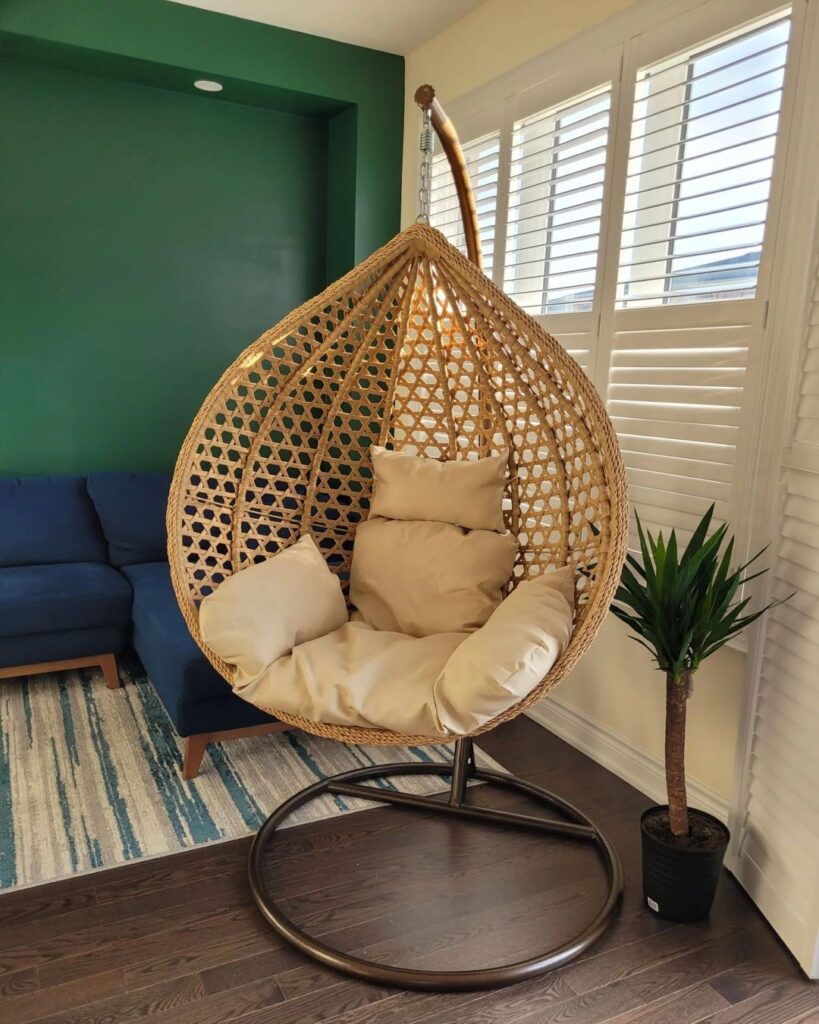 Balanço com base de metal e assento em rattan com almofadas