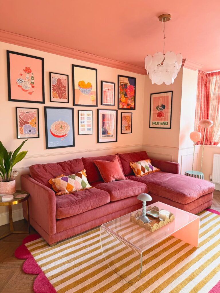 Sala de estar com mesa de centro, quadros e sofá com almofadas