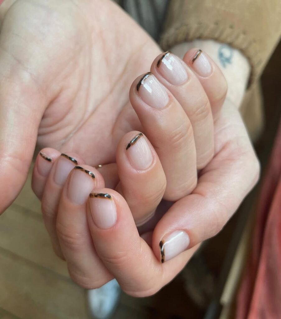 Mãos de pele clara, com micro francesinha animal print 