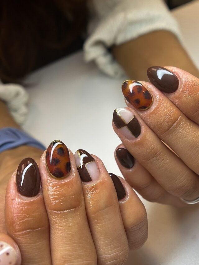 Mão de pele negra com tortoiseshell nails