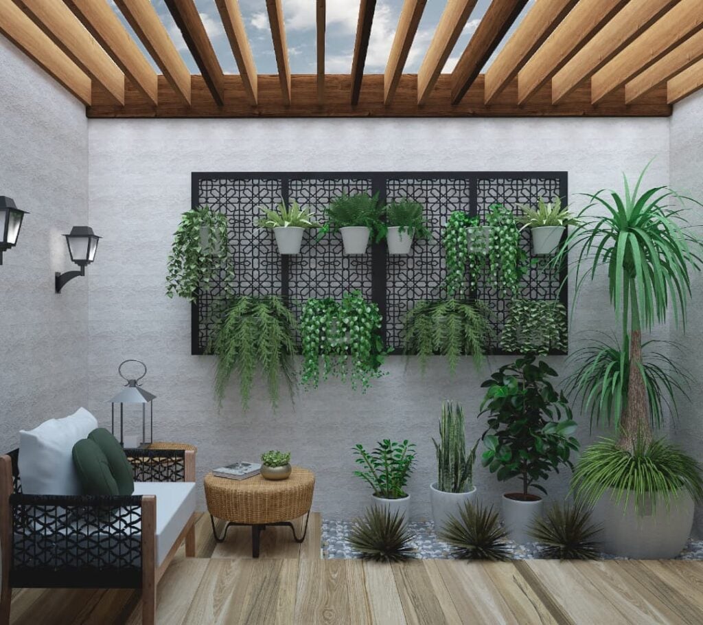 Jardim de inverno com sofá com assento branco, mesa de vime, e plantas de tamanhos diversos