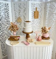 Decoração de chá de cozinha com elementos em mdf branco, itens de madeira e louças rosa-claro com flores