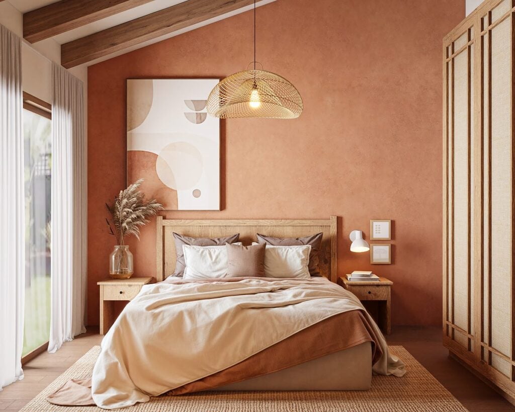 Quarto em tons terrosos na parede, quadro e roupa de cama, e madeira aparente